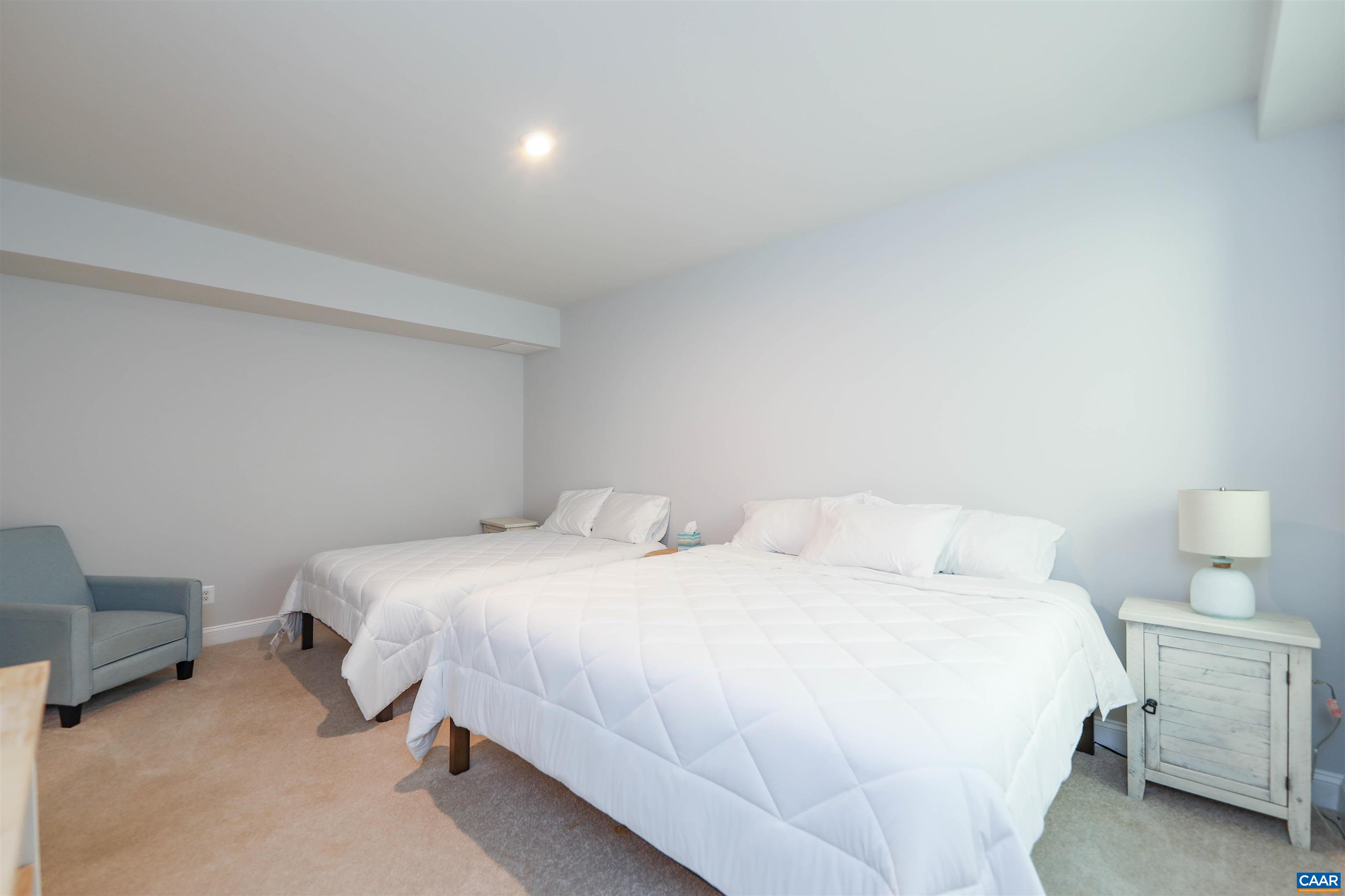 2483 Ferndown Lane Keswick, VA 22947 - Photo 42 of 54 a bedroom with a bed and a chair