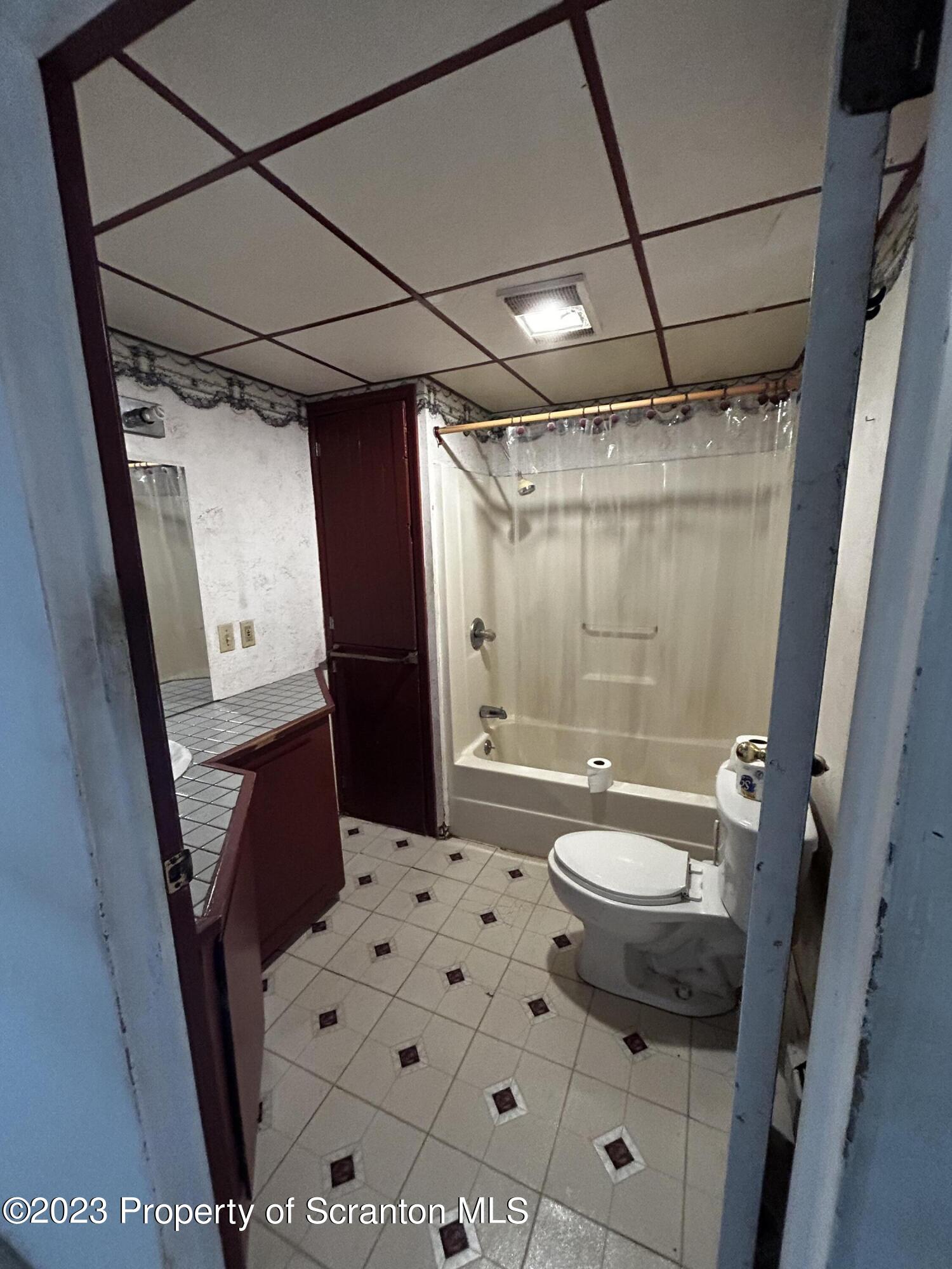 794 Coxton Road Duryea, PA 18642 - Photo 12 of 24 a bathroom with a sink a toilet a mirror and shower