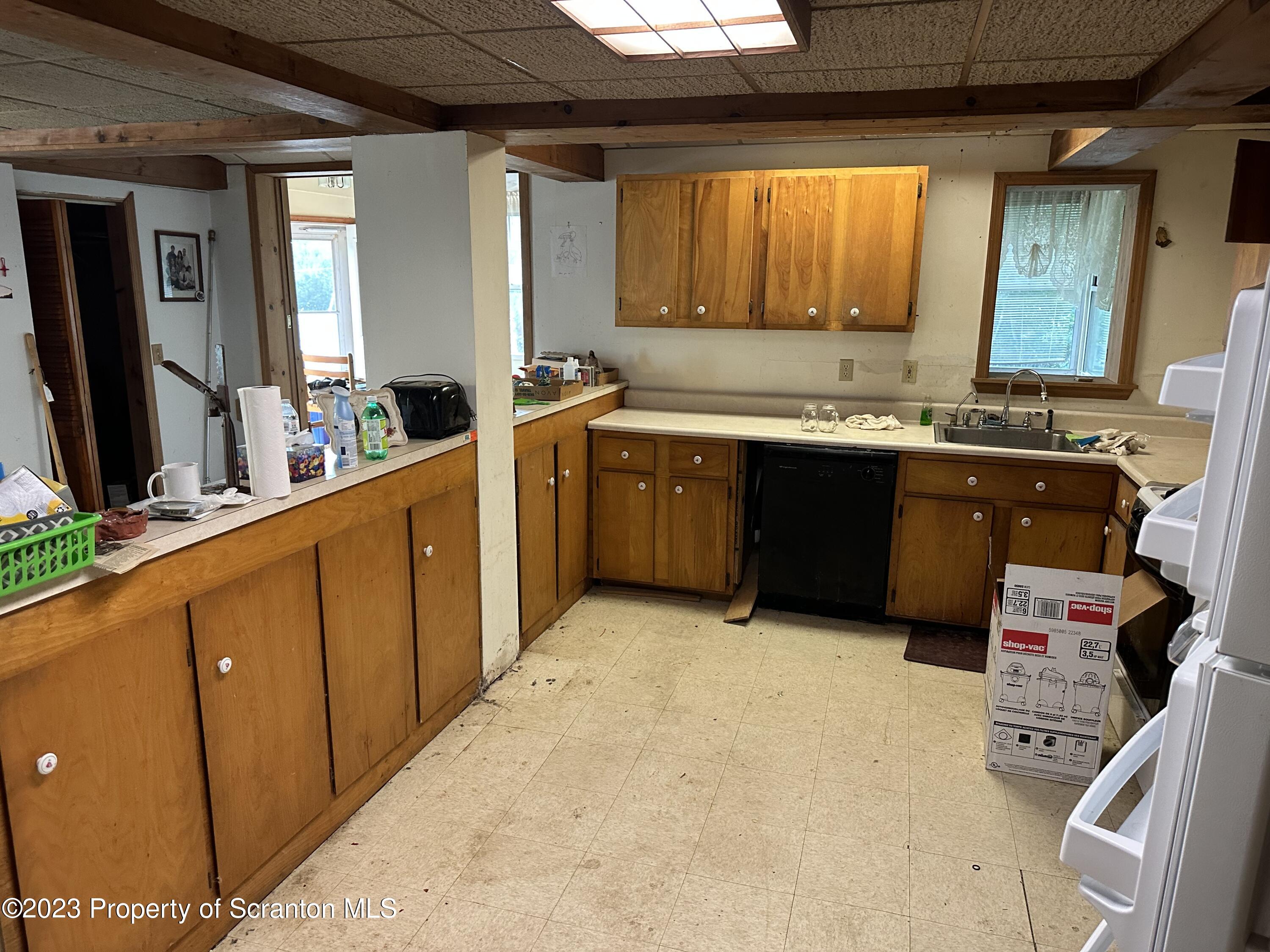 794 Coxton Road Duryea, PA 18642 - Photo 9 of 24 a large kitchen with kitchen island granite countertop a sink and cabinets