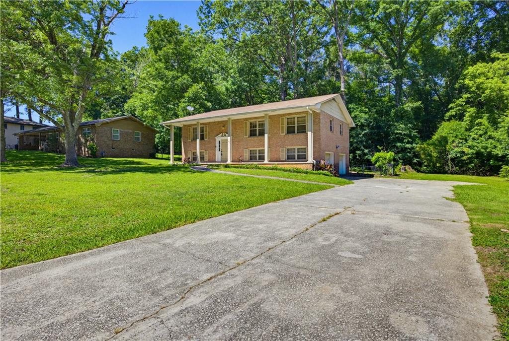 4188 Cedar Valley Lane Conley, GA 30288 - Photo 28 of 28 a front view of a house with a yard and trees