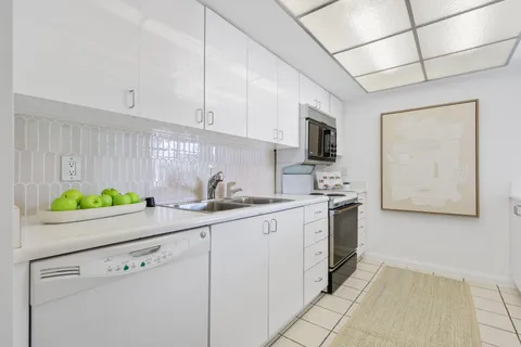 a kitchen with stainless steel appliances white cabinets and a sink