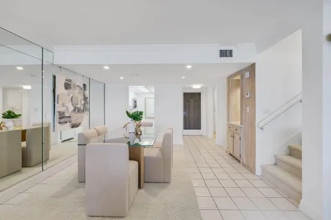 a living room with furniture and a dining table with kitchen view