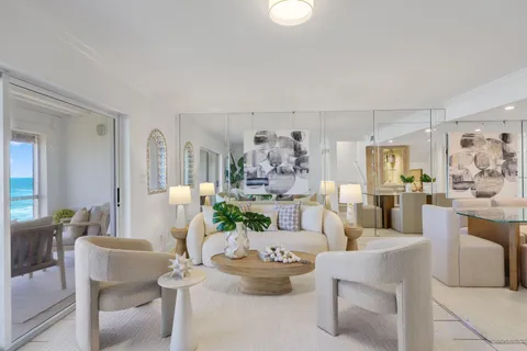 a living room with furniture and a dining table