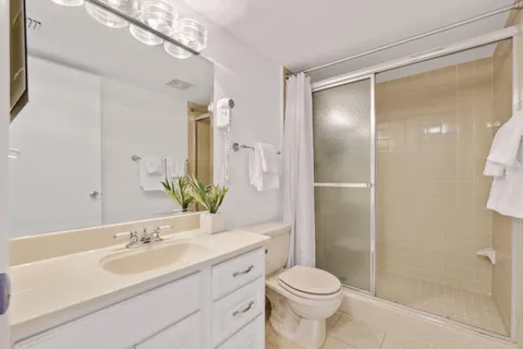 a bathroom with a sink toilet and shower