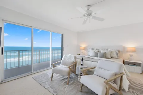 a living room with furniture and a floor to ceiling window