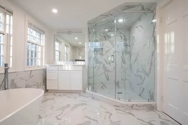 a bathroom with a bathtub and a shower