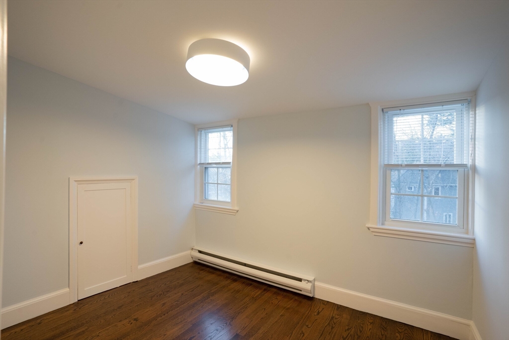 40 Puddingstone Lane Newton, MA 02459 - Photo 22 of 32 an empty room with wooden floor and windows
