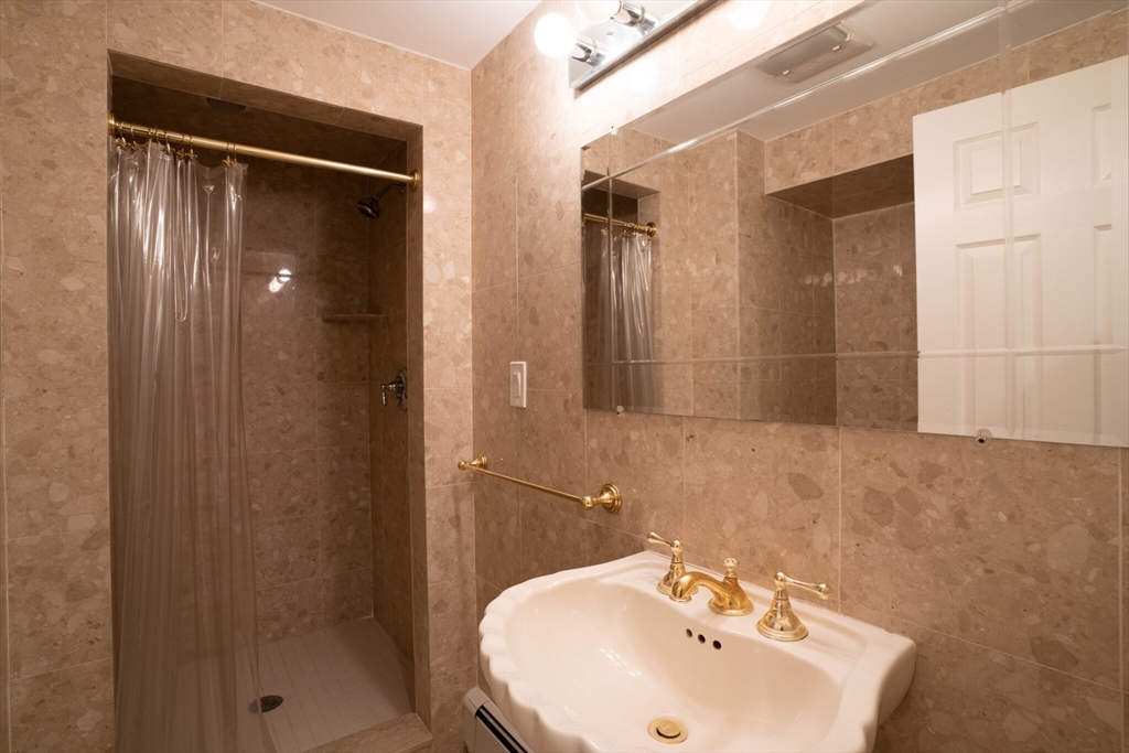40 Puddingstone Lane Newton, MA 02459 - Photo 24 of 32 a bathroom with a sink mirror and shower