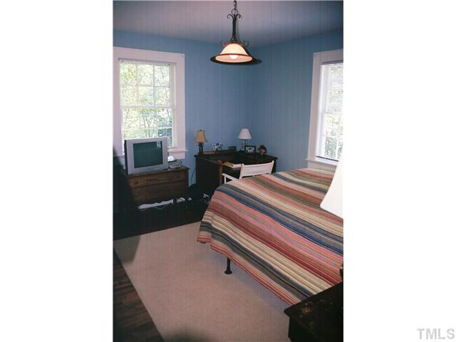 3306 Hall Street Raleigh, NC 27607 - Photo 2 of 6 a bedroom with a bed and a window