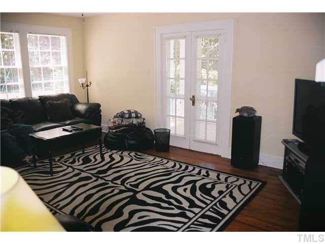 3306 Hall Street Raleigh, NC 27607 - Photo 3 of 6 a bedroom with a bed and wooden floor