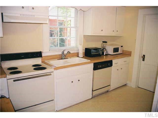 3306 Hall Street Raleigh, NC 27607 - Photo 6 of 6 a kitchen with cabinets appliances a sink and a window