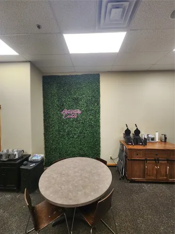 a living room with stainless steel appliances lots of white furniture