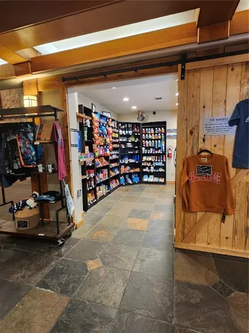 a living room with furniture pool table and a fireplace