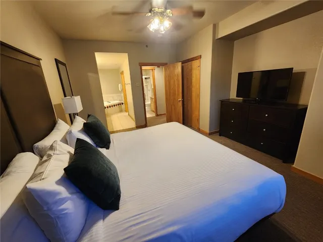 a bedroom with a bed window and television