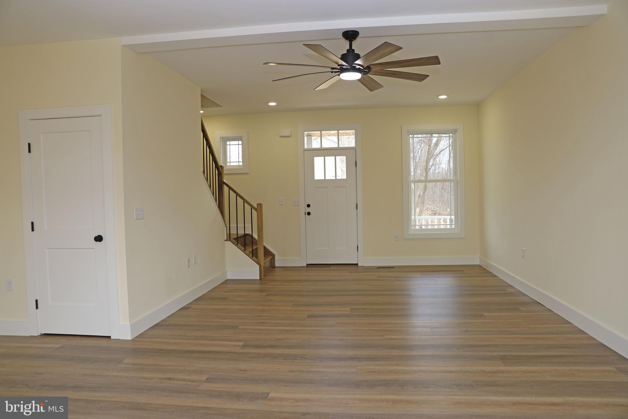 69 Bait Road Inwood, WV 25428 - Photo 5 of 52 a view of an empty room with wooden floor and a window
