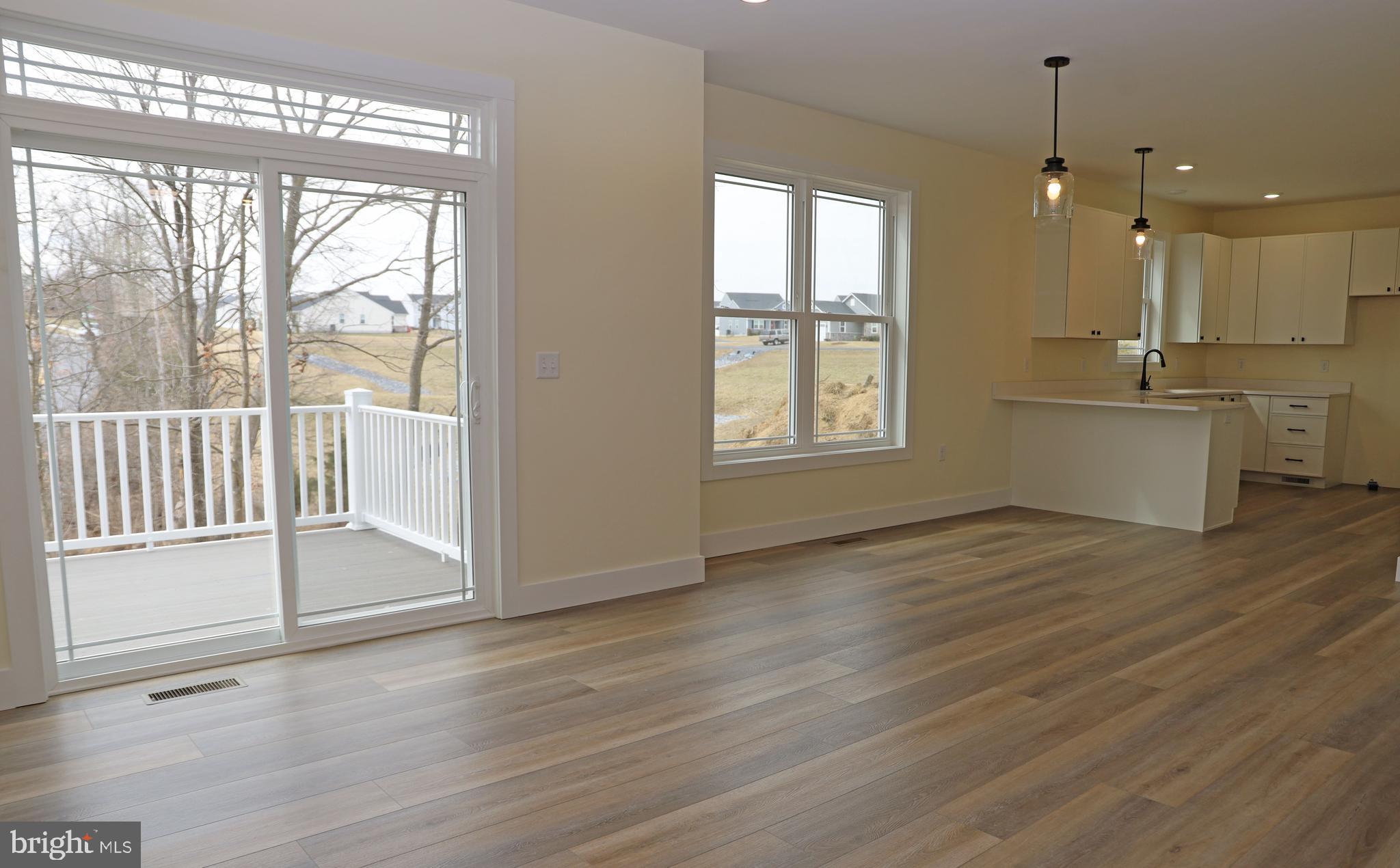 69 Bait Road Inwood, WV 25428 - Photo 8 of 52 a view of an empty room with wooden floor and a window