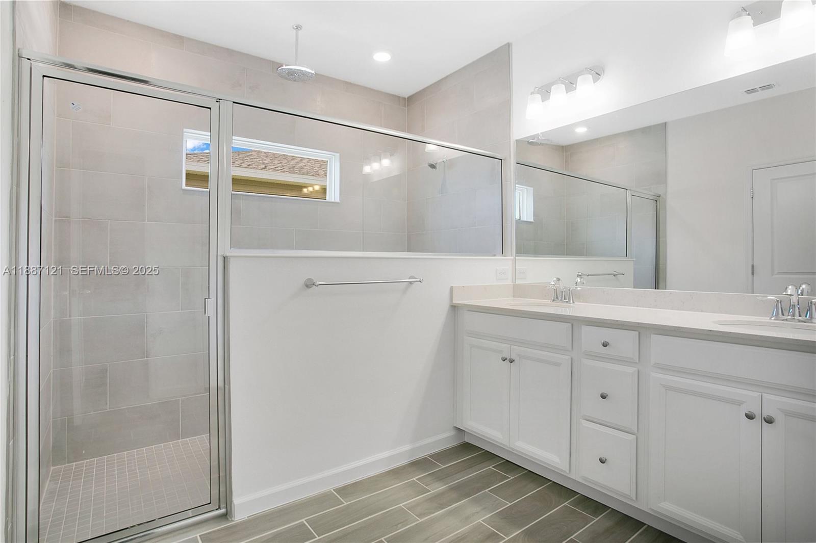 7796 Southwest 74th Loop Ocala, FL 34481 - Photo 11 of 20 a bathroom with a shower sink and mirror
