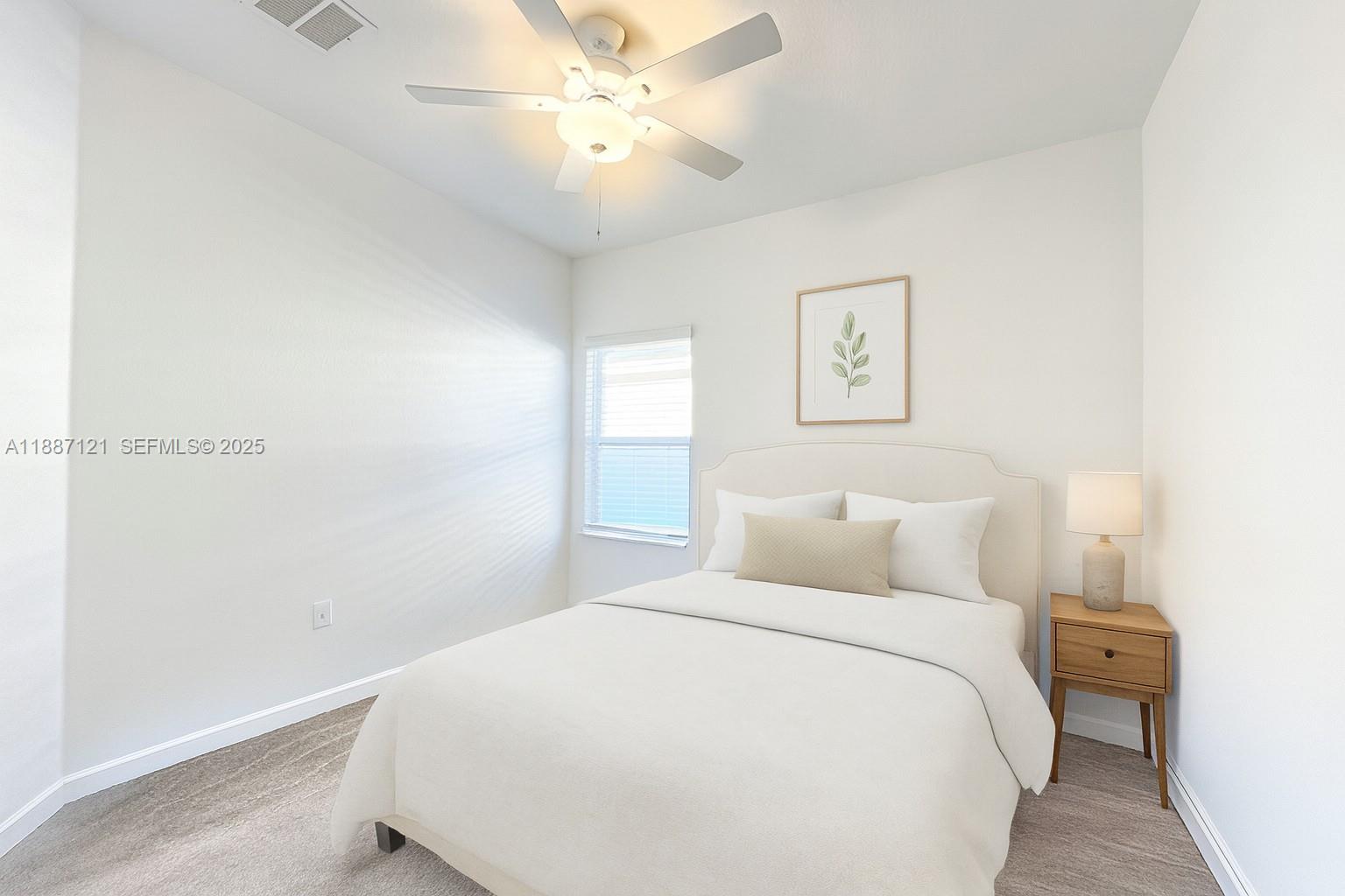 7796 Southwest 74th Loop Ocala, FL 34481 - Photo 9 of 20 a bedroom with a bed and a chandelier