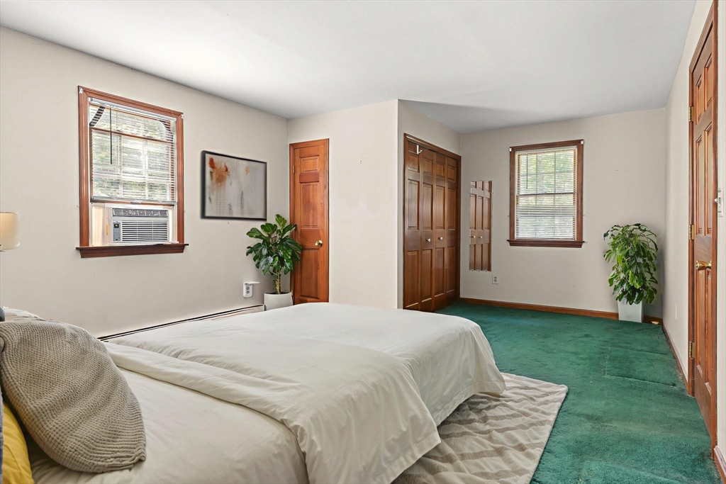 31 Kimball Road Amesbury, MA 01913 - Photo 19 of 40 a spacious bedroom with a bed a window and potted plant