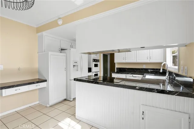a kitchen with stainless steel appliances granite countertop a sink and a stove