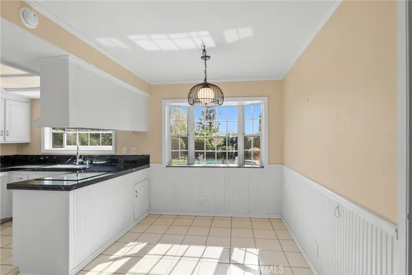 a kitchen with granite countertop a stove and a sink