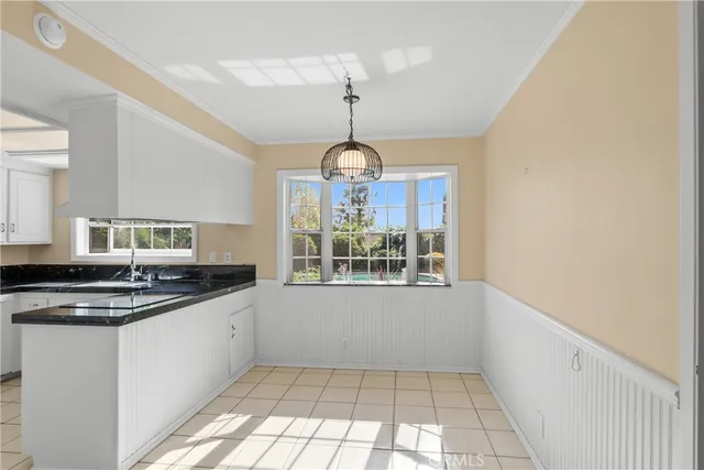 a kitchen with granite countertop a stove and a sink