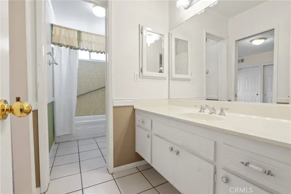 a bathroom with a shower sink and mirror