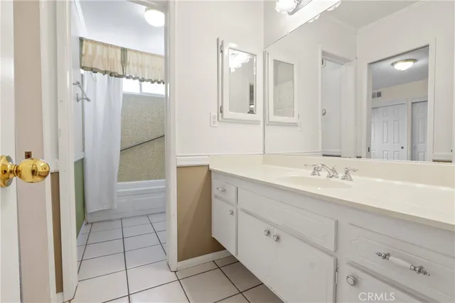 a bathroom with a shower sink and mirror