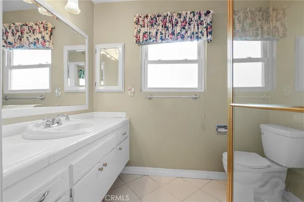 a bathroom with a sink toilet and window