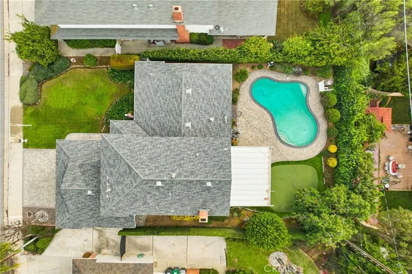an aerial view of a house with a swimming pool