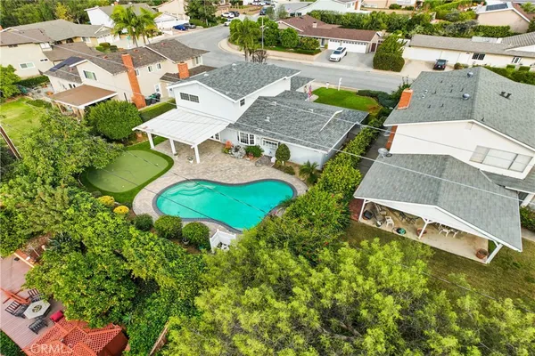 an aerial view of a house with garden space and street view