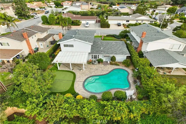 an aerial view of residential houses with outdoor space and street view