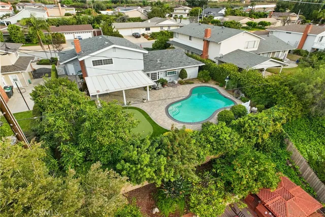 an aerial view of residential houses with outdoor space and street view