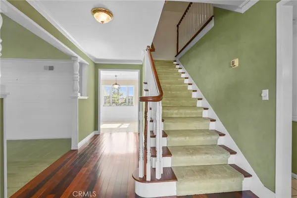 a view of entryway and hall with wooden floor