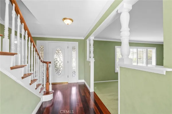 a view of entryway with wooden floor and stairs