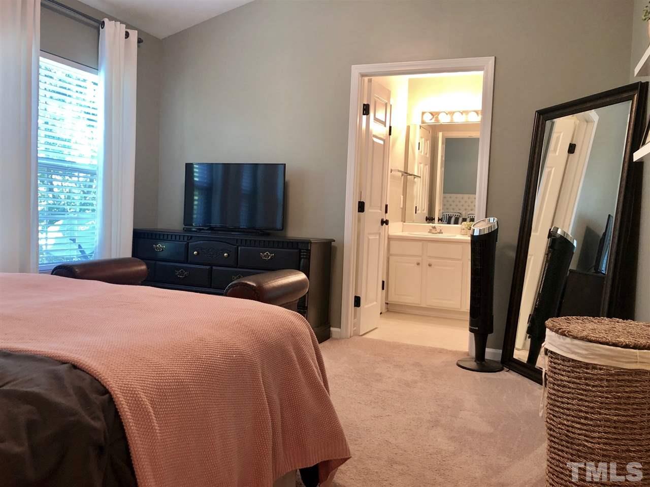 8126 Rhiannon Road Raleigh, NC 27613 - Photo 14 of 24 a bedroom with a bed and a dresser