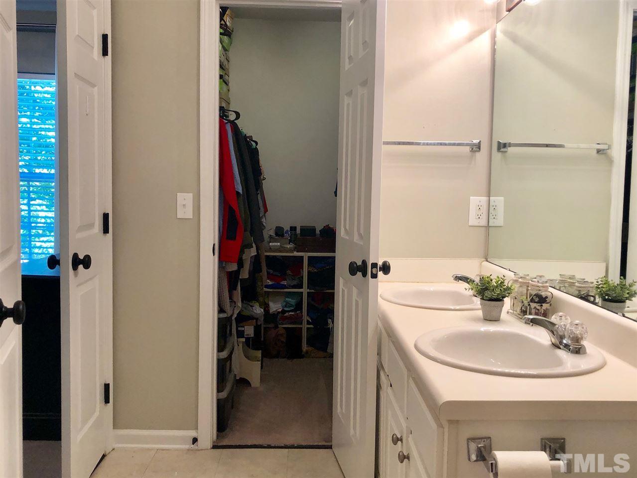 8126 Rhiannon Road Raleigh, NC 27613 - Photo 18 of 24 a bathroom with a sink and a mirror
