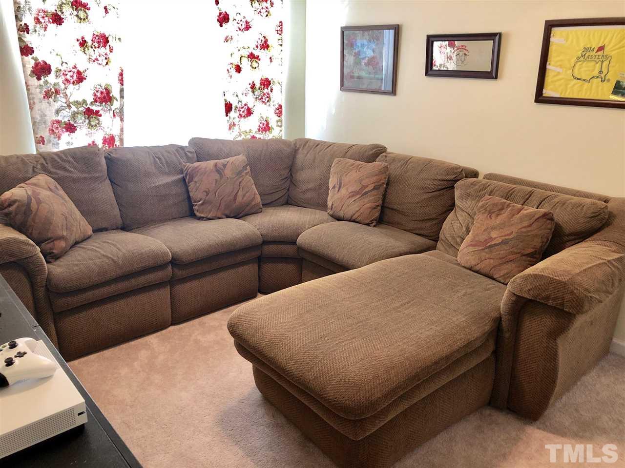 8126 Rhiannon Road Raleigh, NC 27613 - Photo 21 of 24 a blue couch sitting next to a white couch