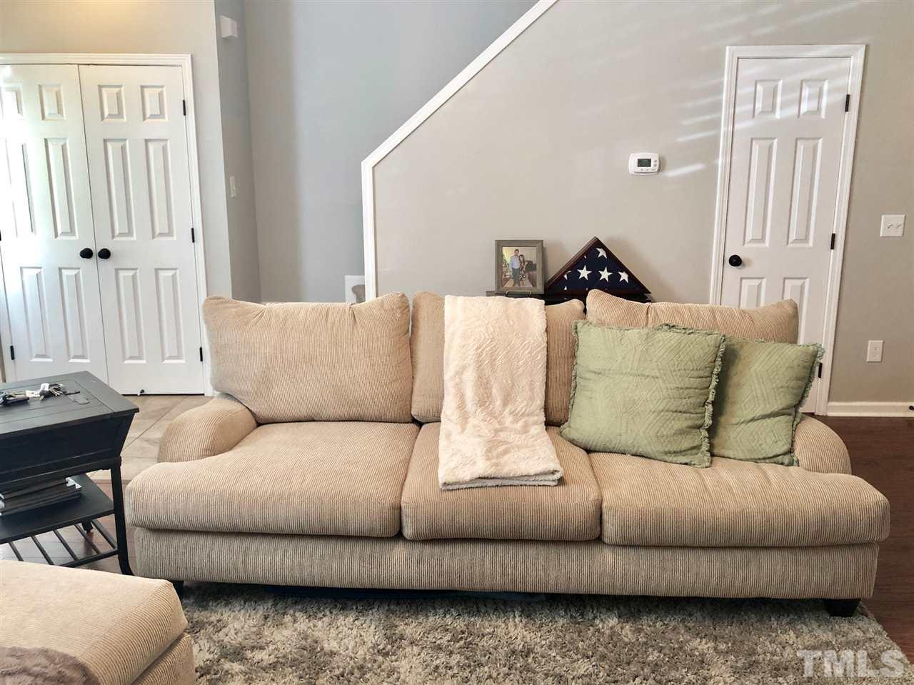 8126 Rhiannon Road Raleigh, NC 27613 - Photo 8 of 24 a living room with furniture and a couch