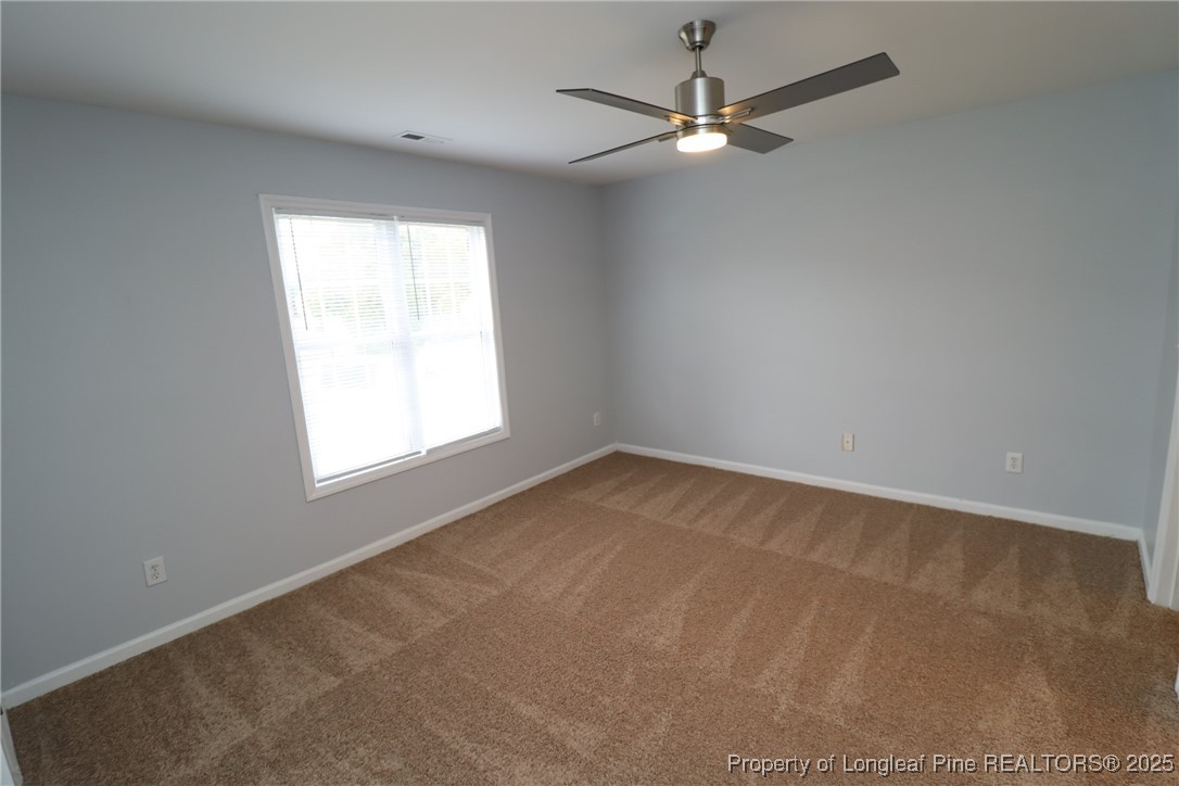 4105 Scofield Drive Raleigh, NC 27610 - Photo 13 of 27 an empty room with a window and a fan