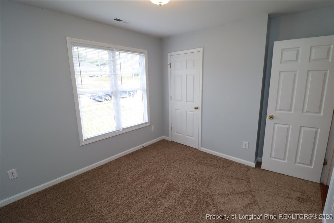 4105 Scofield Drive Raleigh, NC 27610 - Photo 22 of 27 an empty room with windows