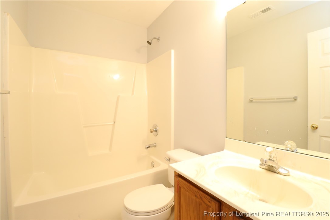 4105 Scofield Drive Raleigh, NC 27610 - Photo 27 of 27 a bathroom with a granite countertop sink toilet and shower