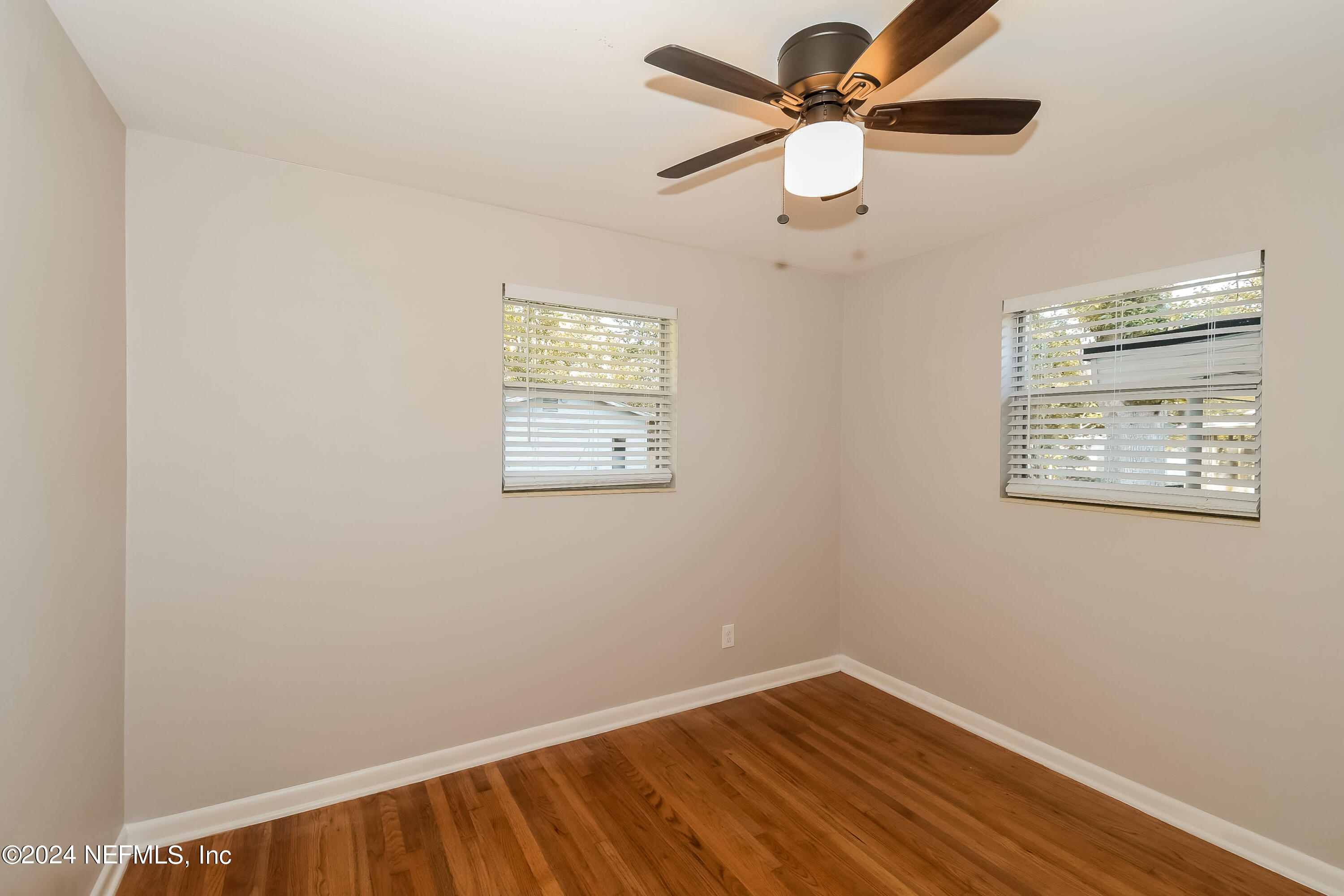 7070 Perke Drive Jacksonville, FL 32210 - Photo 13 of 16 an empty room with a window and a ceiling fan