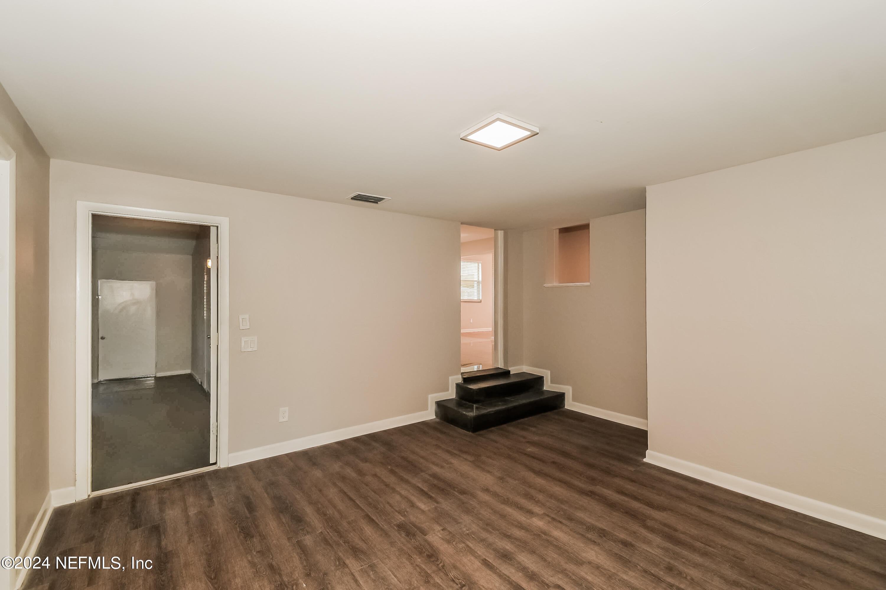 7070 Perke Drive Jacksonville, FL 32210 - Photo 5 of 16 a view of empty room with wooden floor