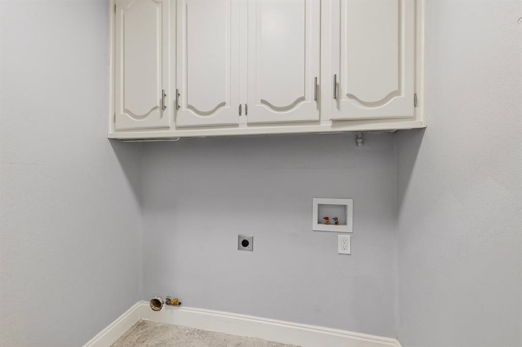 7631 Meadow Road Dallas, TX 75230 - Photo 30 of 40 A spacious utility room with built-in cabinets, ready for a washer and dryer hook up.