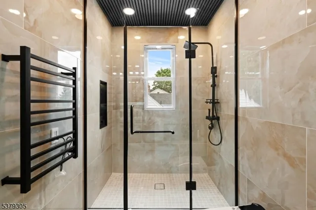 a bathroom with a shower and a mirror