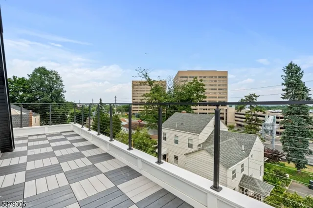 a bathroom with a granite countertop sink and a toilet