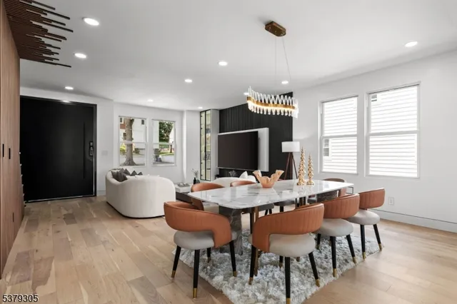 a large dining space with furniture window and wooden floor