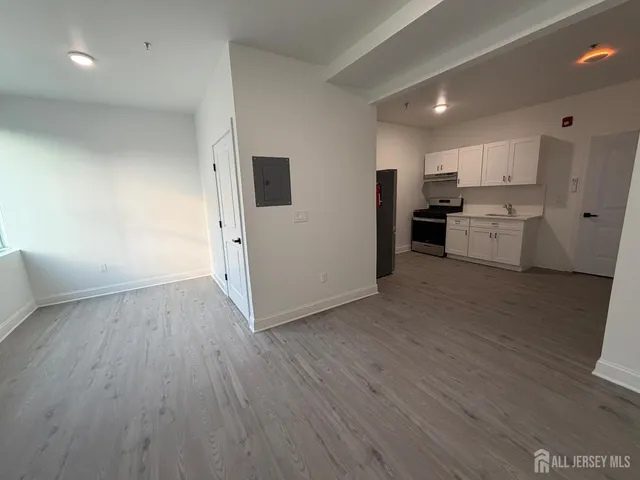 a view of a kitchen with wooden floor