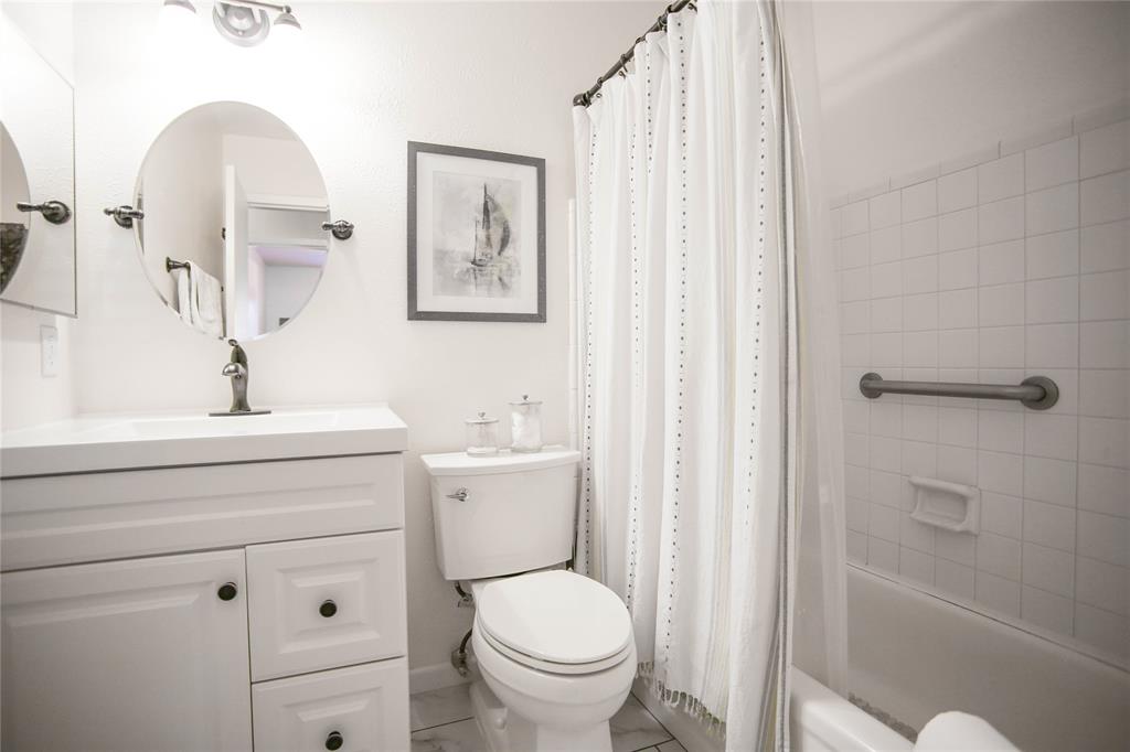 1720 Crystal Way Plano, TX 75074 - Photo 26 of 32 a bathroom with a toilet a sink and a mirror